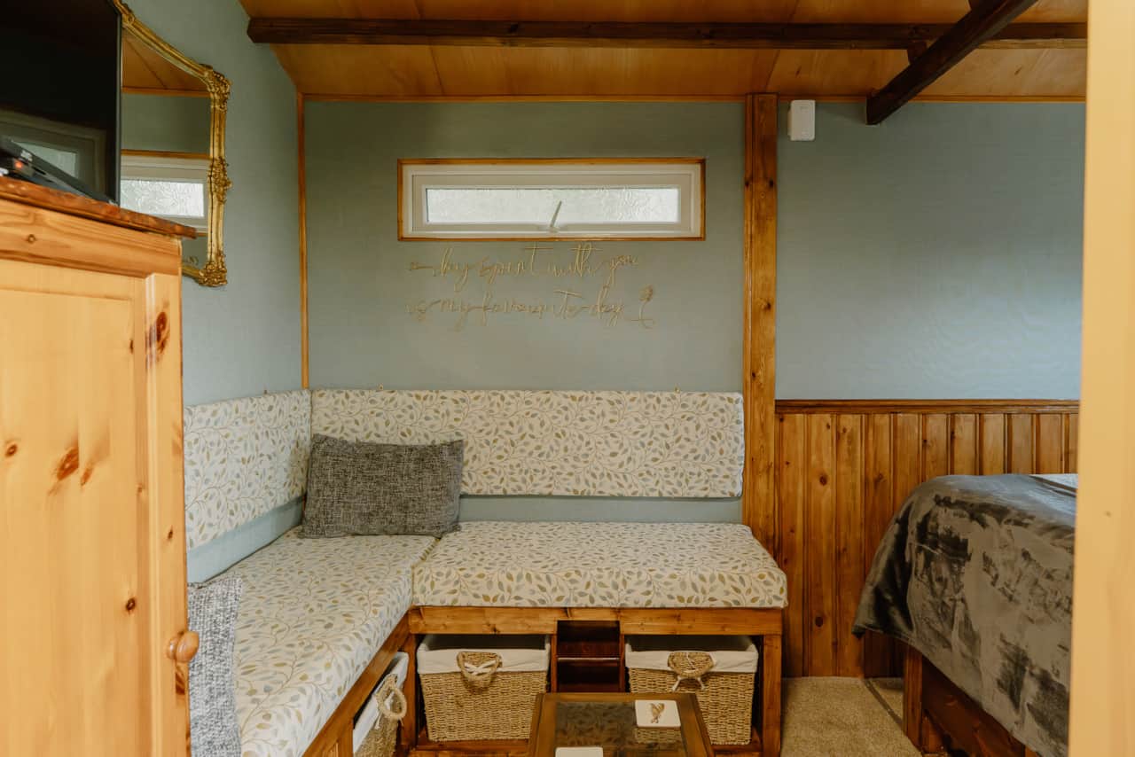 Cushioned bench seating area in the Cosy Nest Hut.