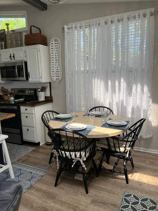 Dining area in kitchen with seating for 4 at  table and seating for 4 at island.