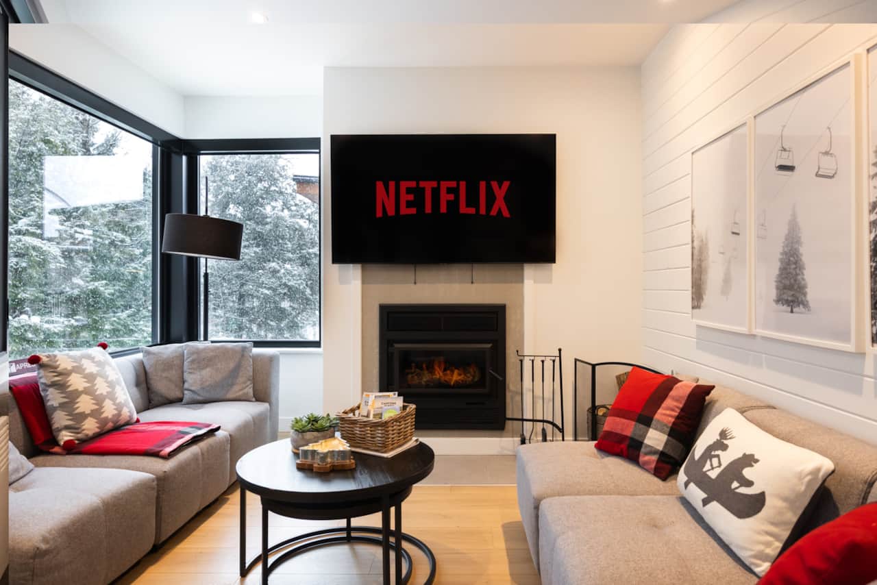 View of the living room with wood burning fire place