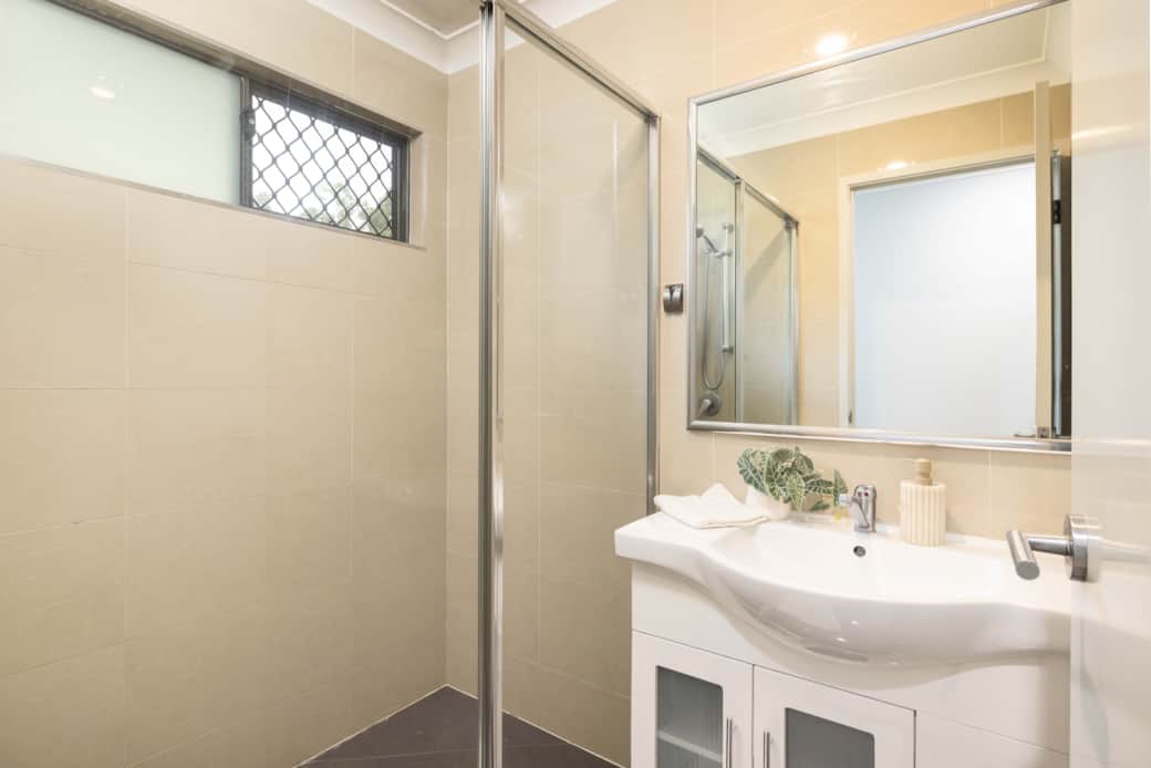 Bathroom: Stylish bathroom with walk-in shower, vanity, and clean finishes