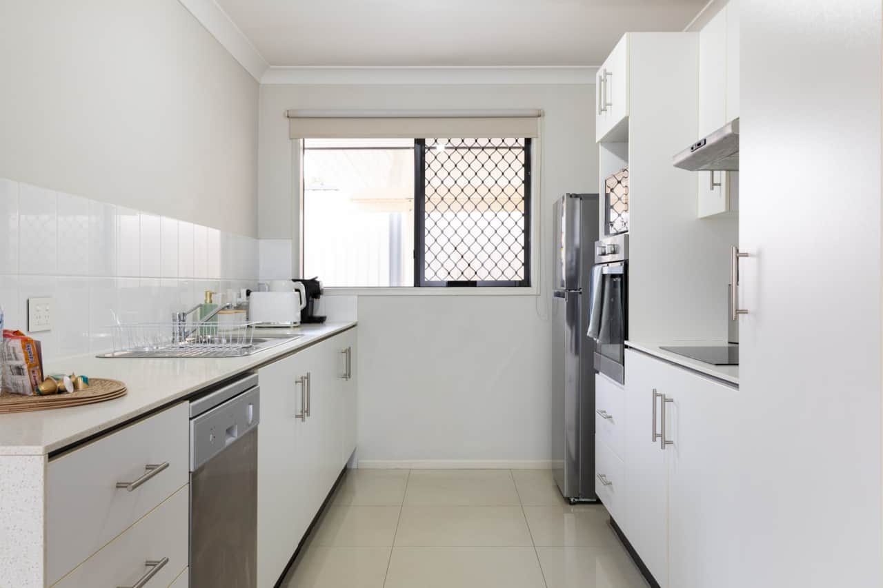 Kitchen: Sleek kitchen with ample storage, modern appliances