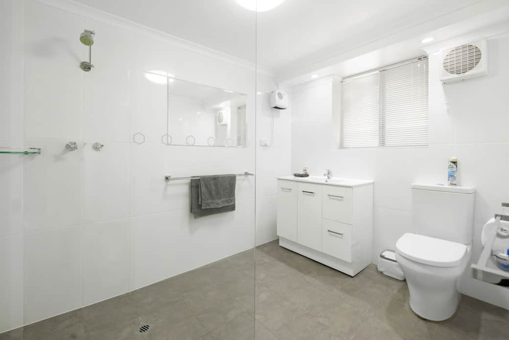 Bathroom 1 is a modern open and airy space with a frameless shower screen. Bathroom 2 is identical