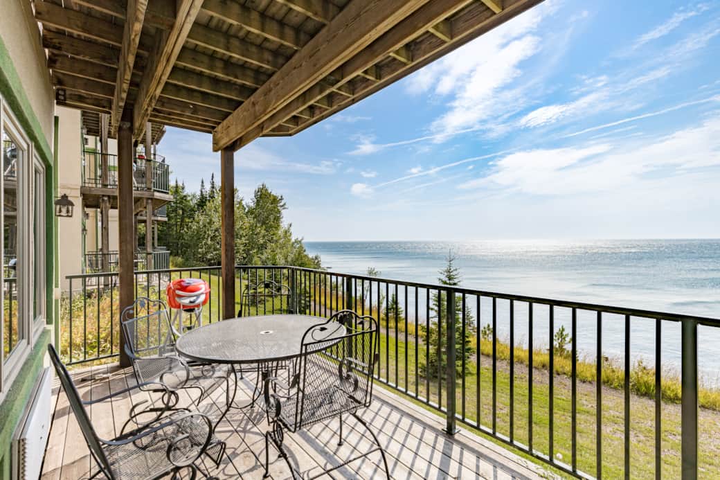 Grill, dine, and unwind—your private balcony with panoramic Lake Superior views