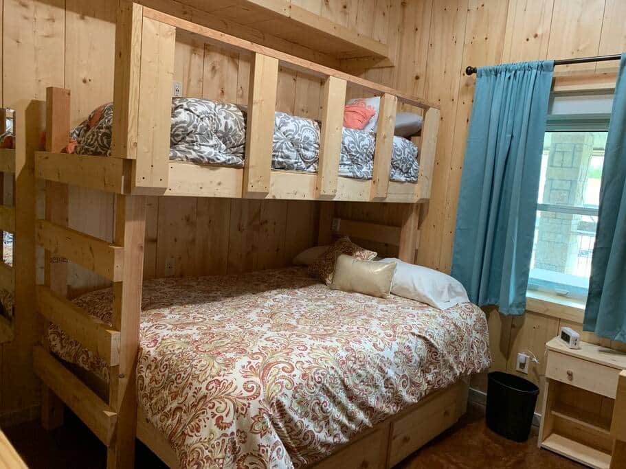 Comfortable bedroom inside the 35-bed Lake Godstone lodge, perfect for family reunion