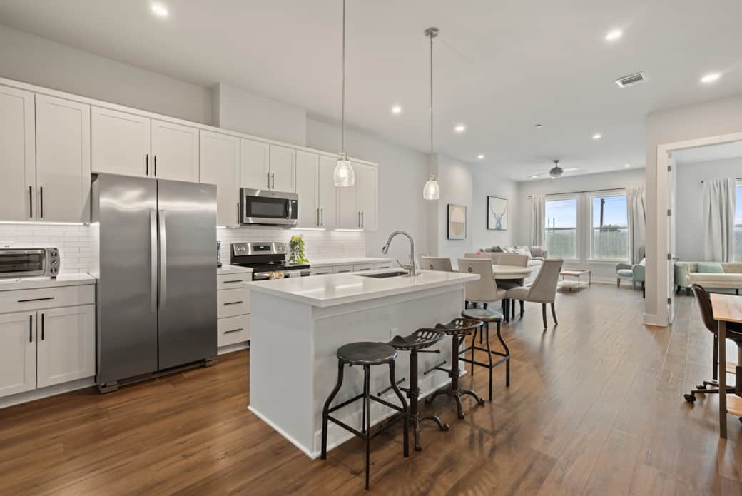 Welcome in — sleek kitchen and inviting living spaces await.