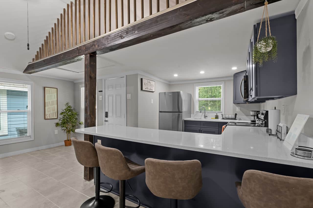 Dining table with fully stocked kitchen view. 