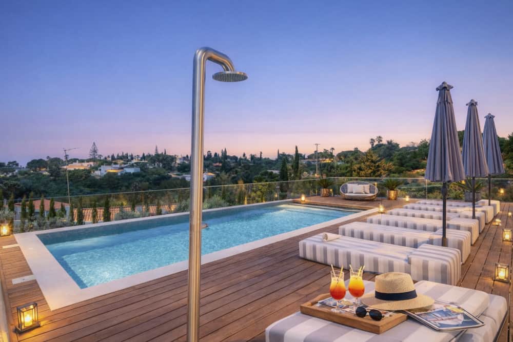 Heated pool and sun loungers of Villa Medusa Paraiso at dusk