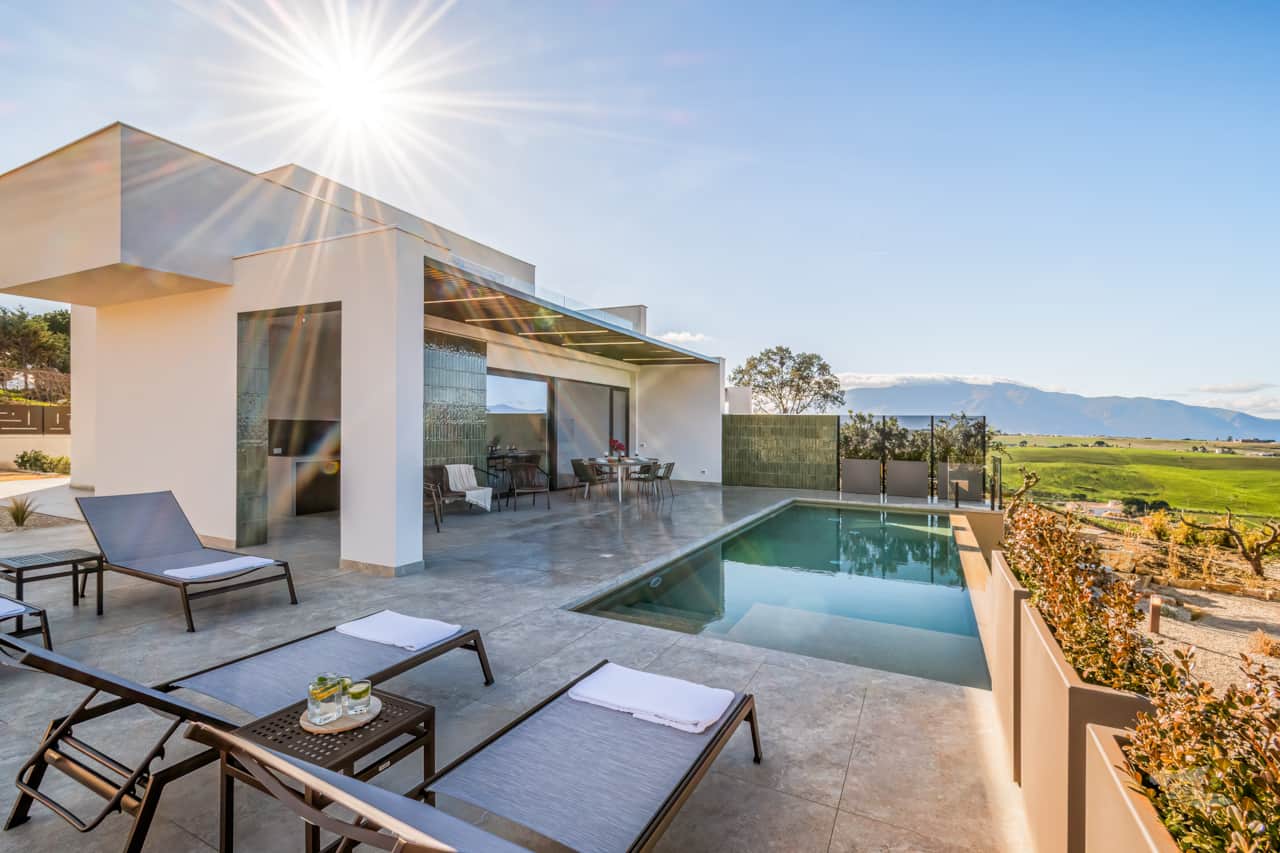 This sunlit terrace offers a seamless blend of modern design and nature.