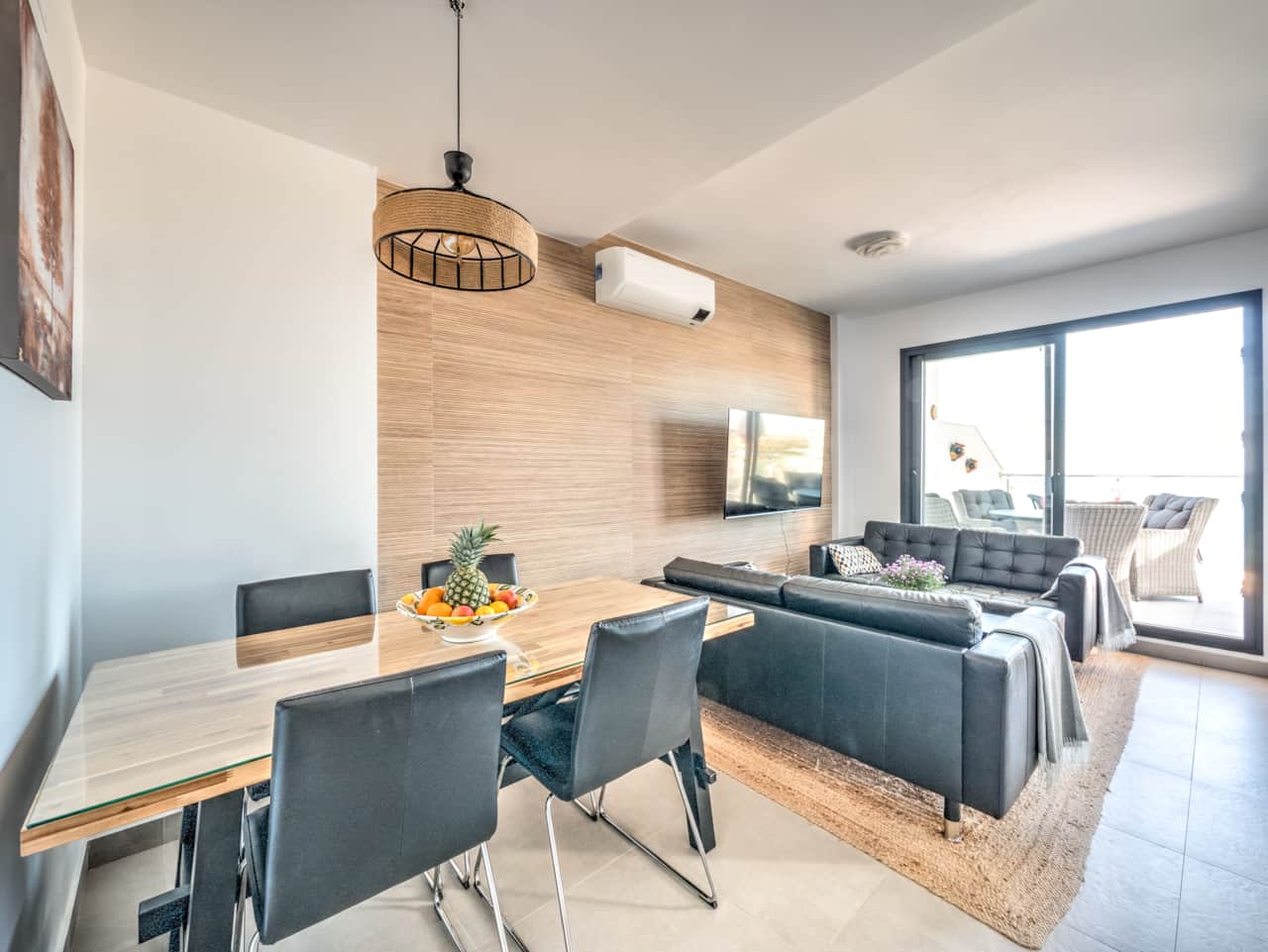 Open plan between dining room and living room. Stylish interior & AC.
