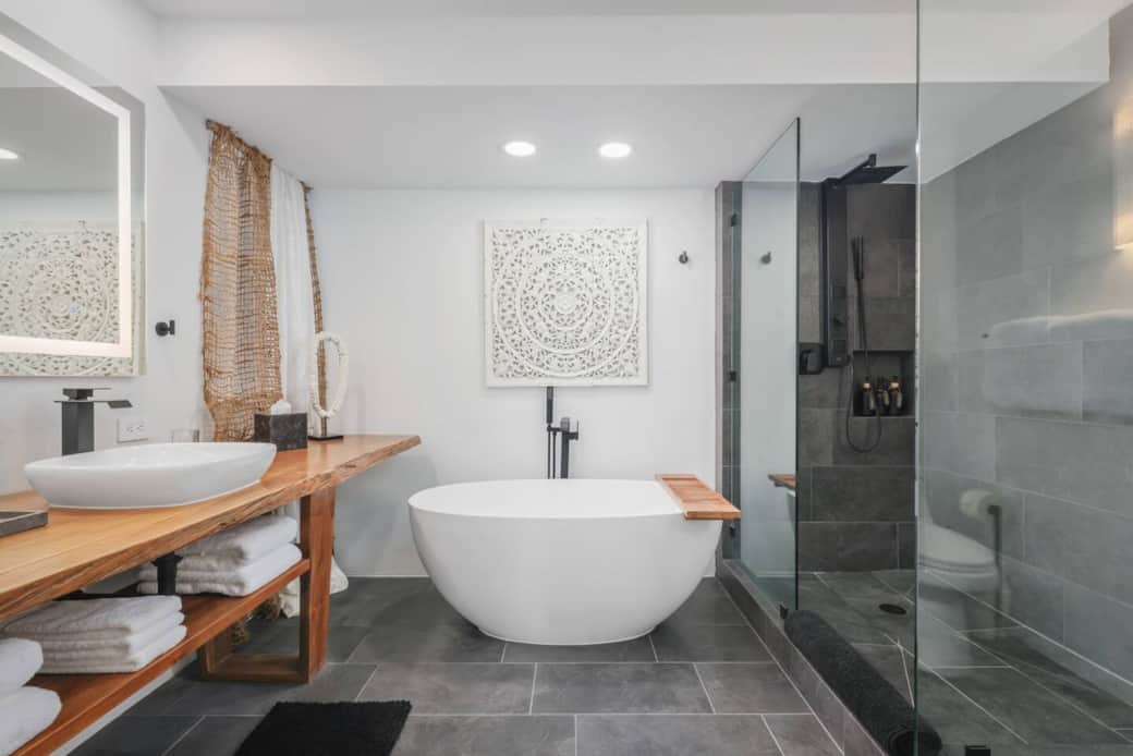 Lux master bath with a freestanding tub, walk-in shower, live-edge vanity with double sinks.