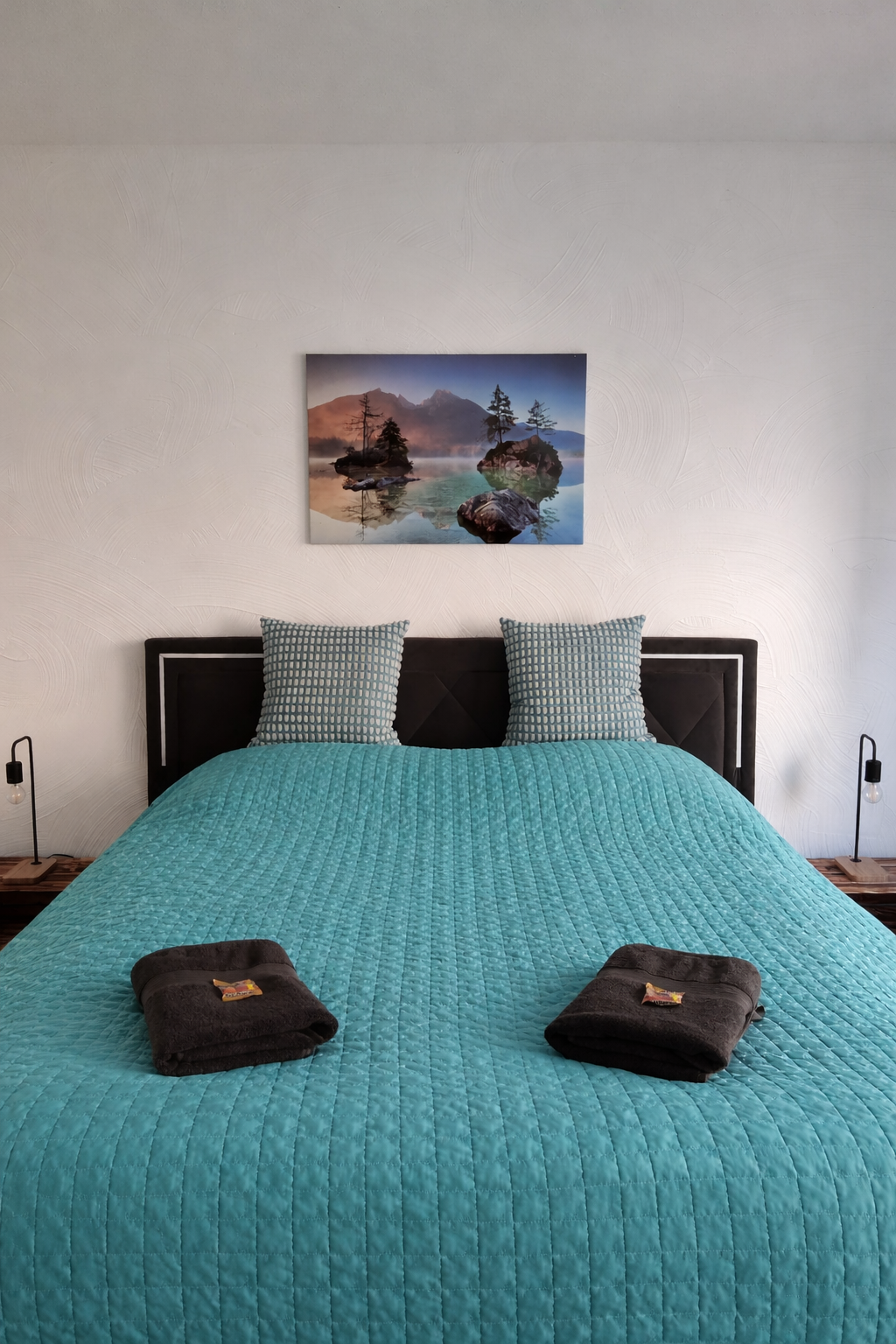 Modernes Schlafzimmer mit türkisfarbener Bettdecke
