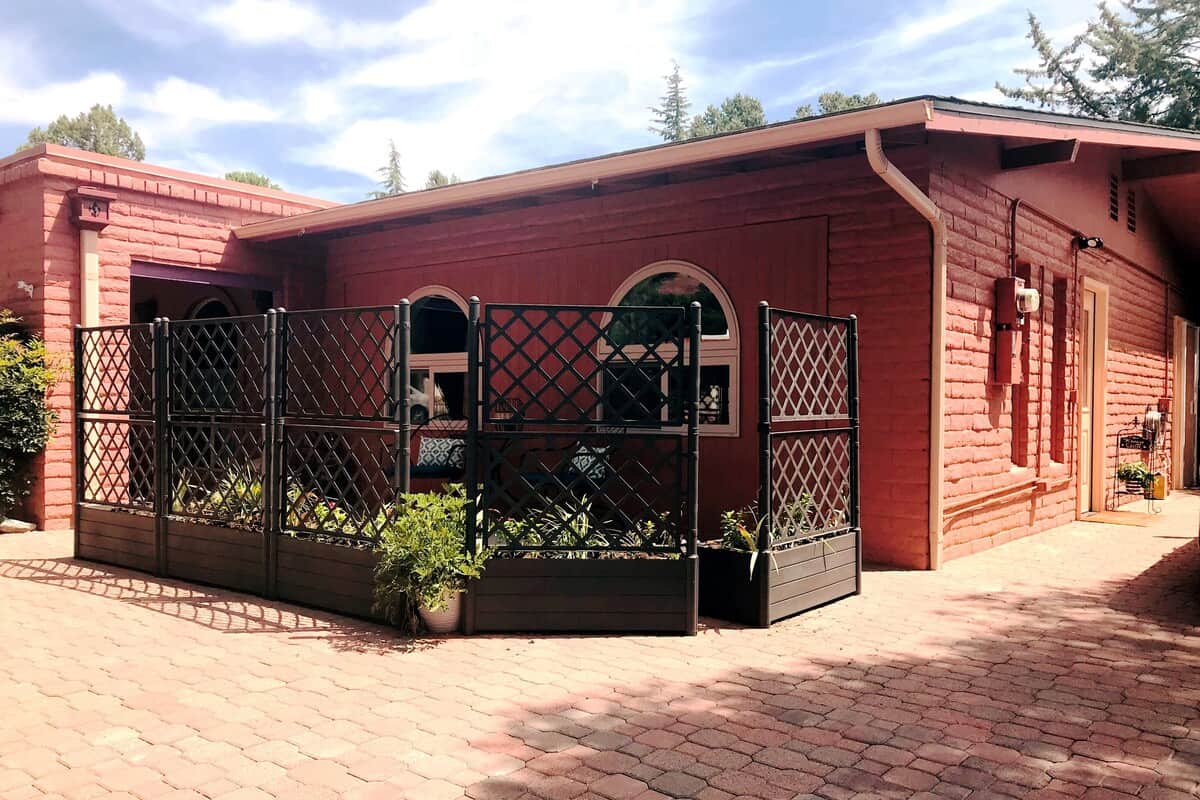 Charming casita exterior with private patio entrance. The fenced courtyard offers a cozy, secluded space to relax while still being just steps away from Sedona’s breathtaking red rock views.