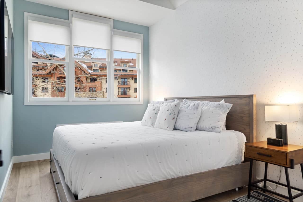 King bed in primary bedroom with vaulted ceilings