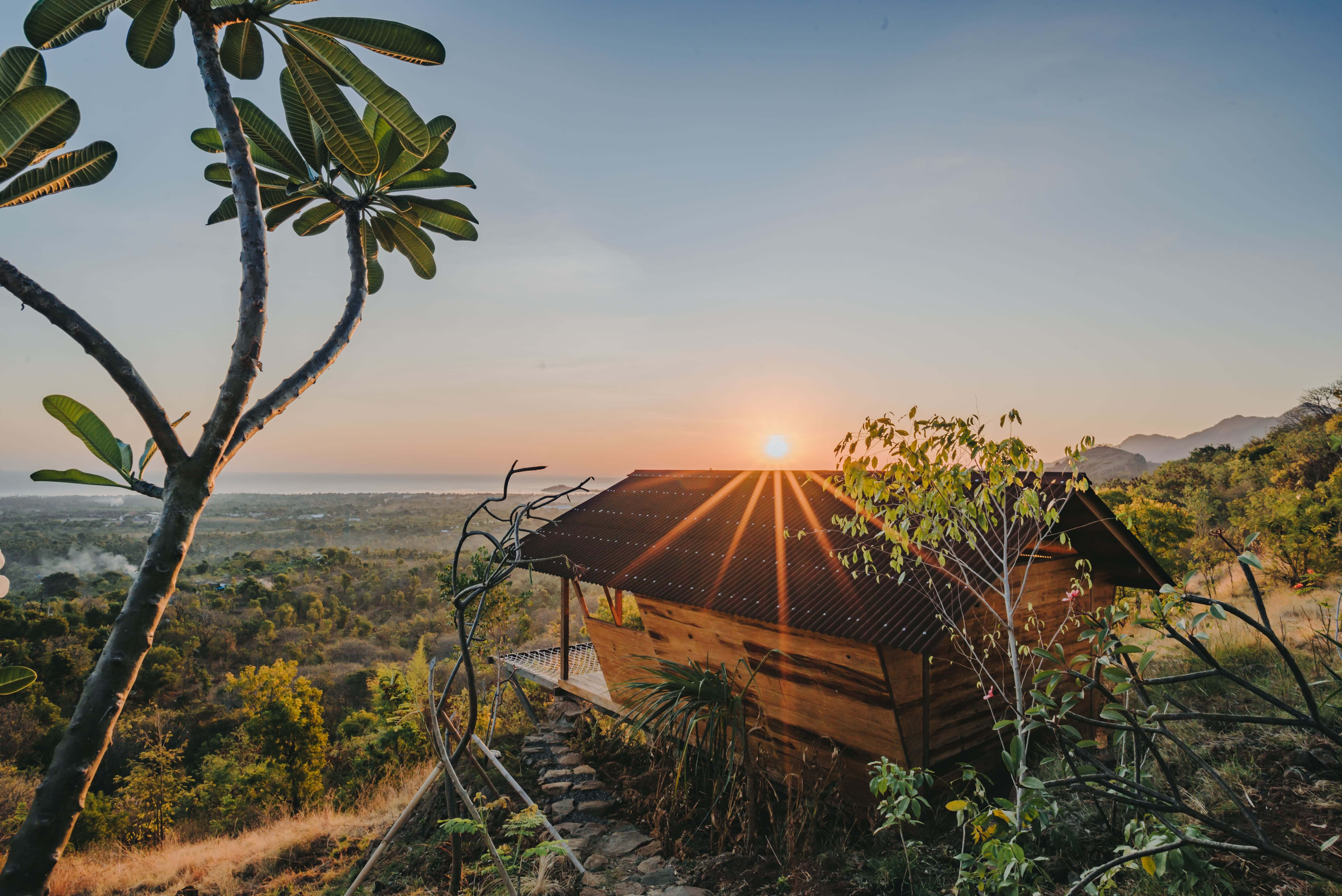 Wooden cabin at sunset with valley and mountain view
