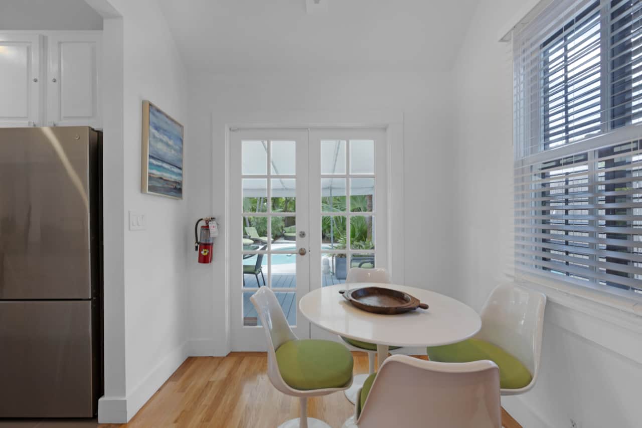 Dining nook with French doors leading to the private pool.