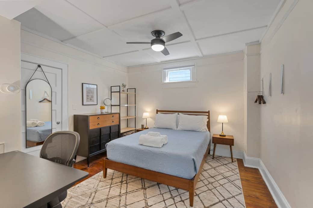 Bedroom #3 w/adjoining door to bedroom #2 closed. Mid century modern highboy dresser,  large shelf and clothes hangers on the wall to store all your belongings during your stay. Full lenght mirror on the door. Motorized sit/stand desk & office chair.