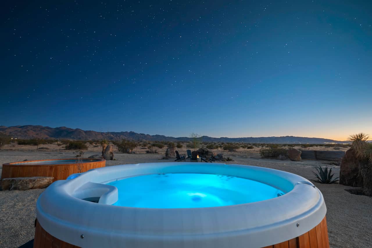 Steaming cedar spa under the emerging stars — your nightly ritual begins