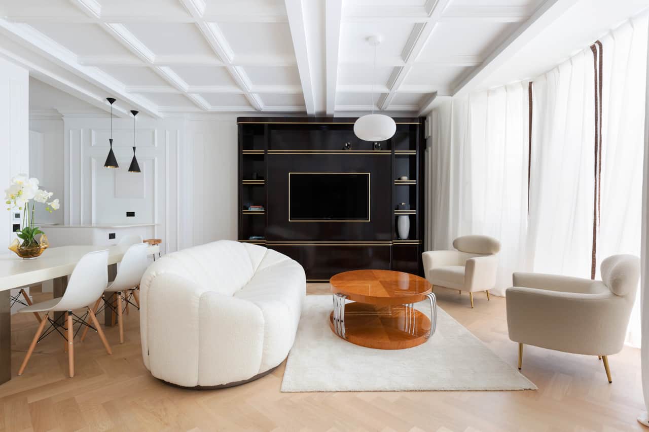 Sumptuous living room with curved boucle sofa and lacquered wood media unit