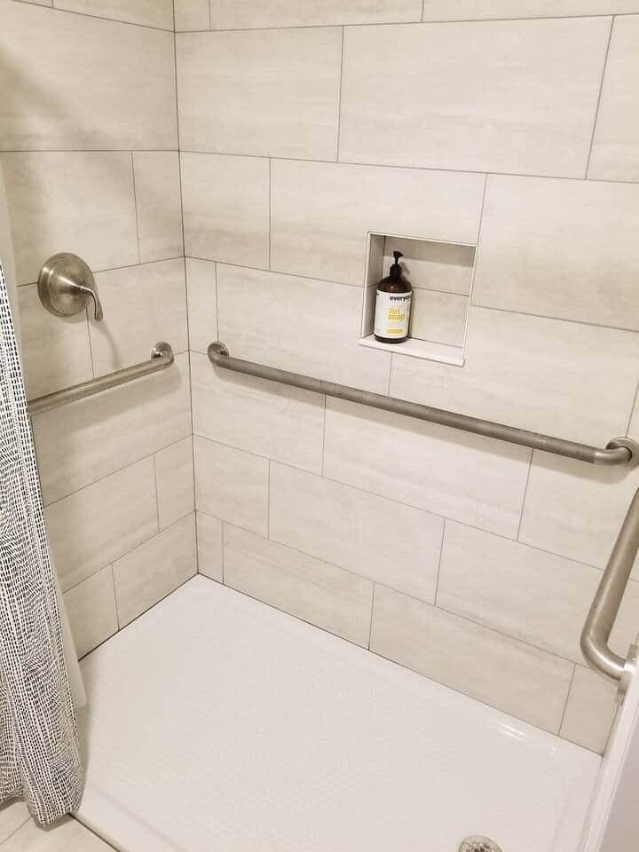 Shower includes grab rails and the ADA compliant pan has only a 1/2" transition from the tile floor.