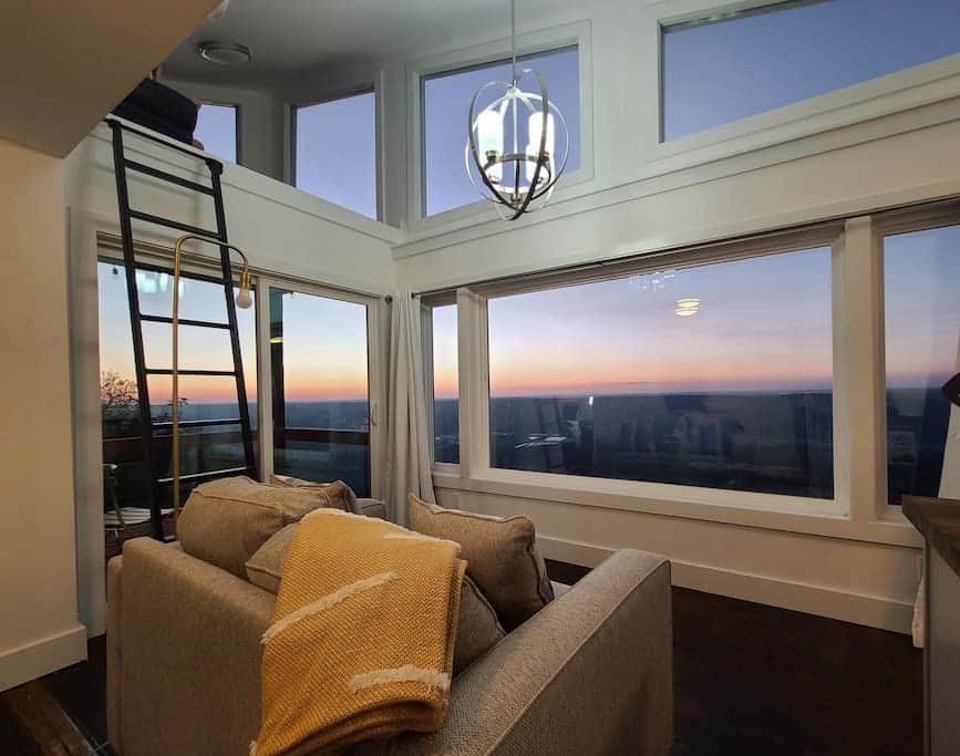 A wall of windows frames breathtaking sunsets over the mountains.