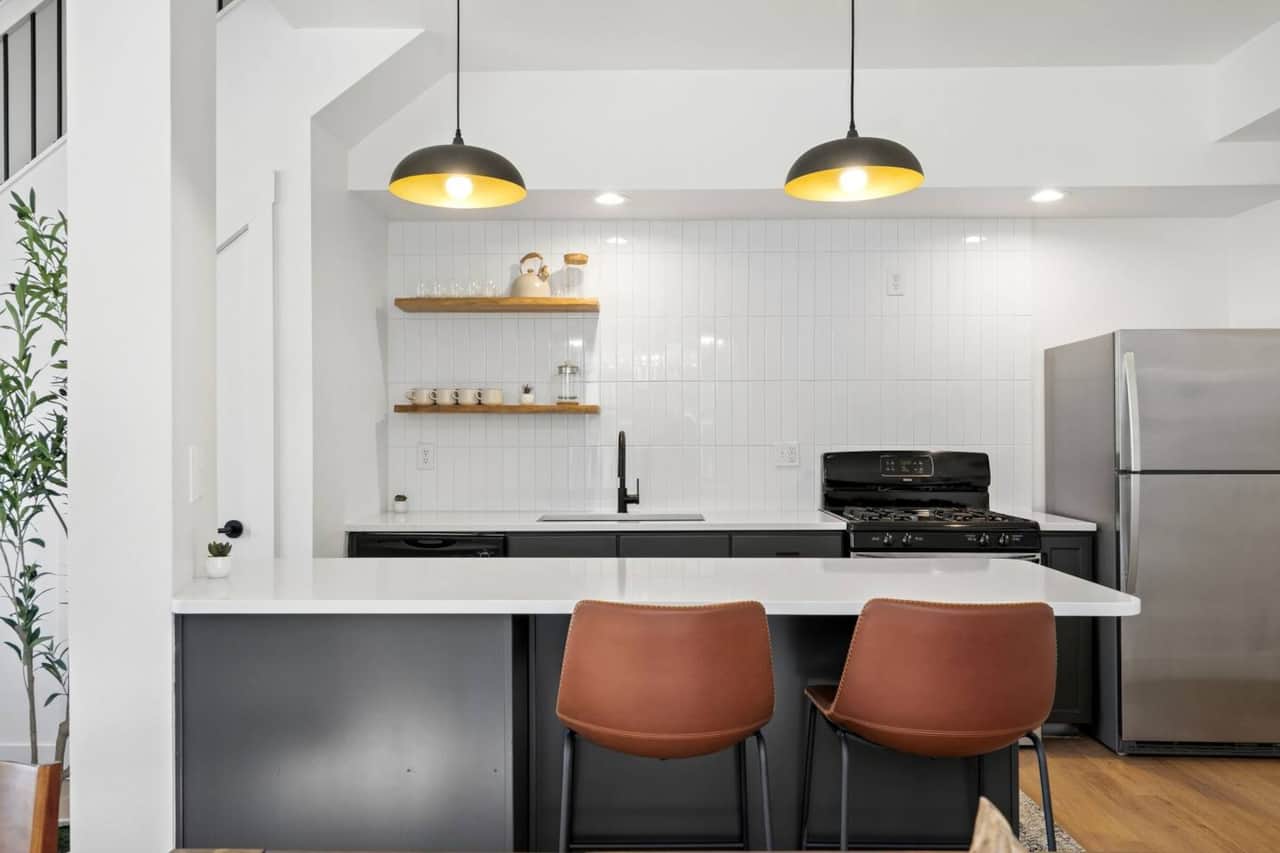 Stylish kitchen island with bar seating and warm pendant lighting—perfect for morning coffee, casual meals, or gathering while you cook.