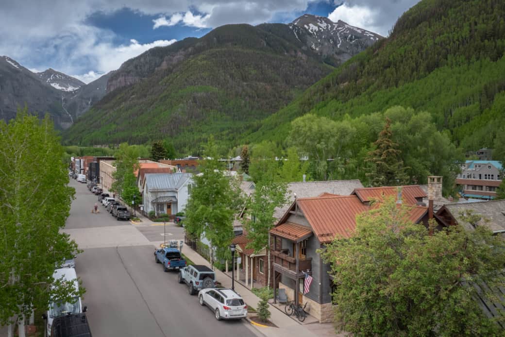 Aerial view of home from W Pacific Street with the box canyon and downtown Telluride in background