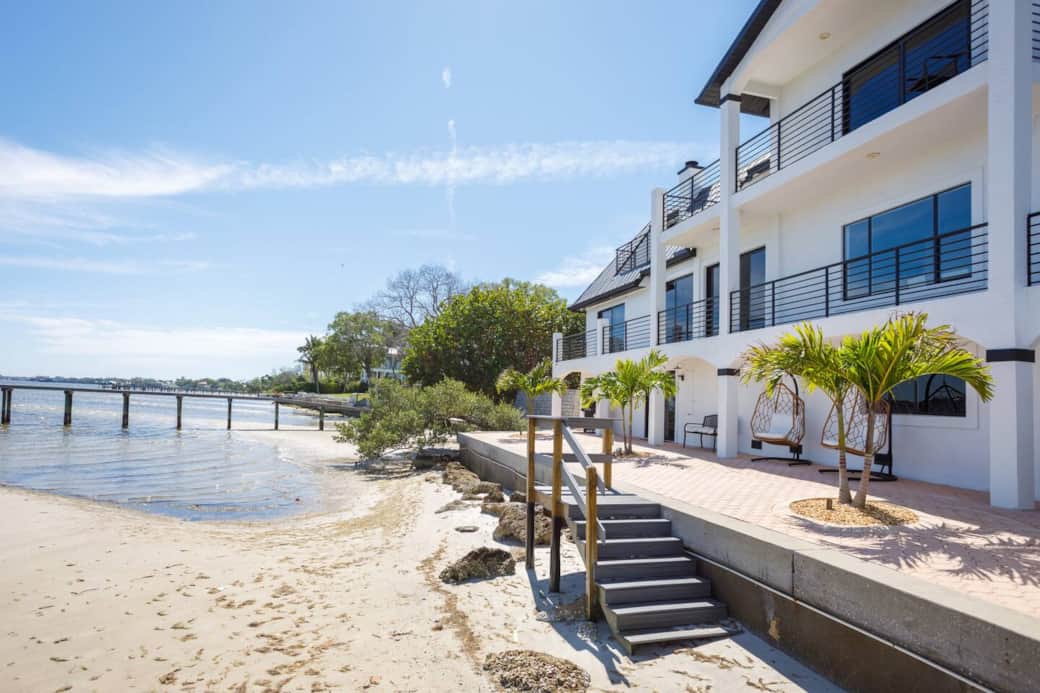 Waterfront patio and river's low-tide  beach with the private apartment located on the bottom floor.