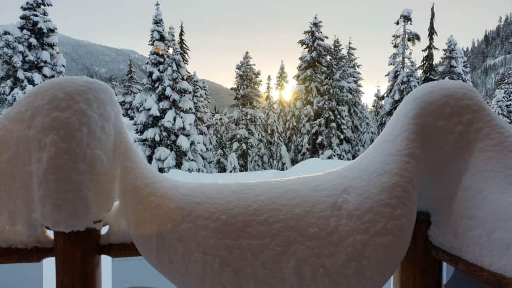 Snow covered railing on front porch.