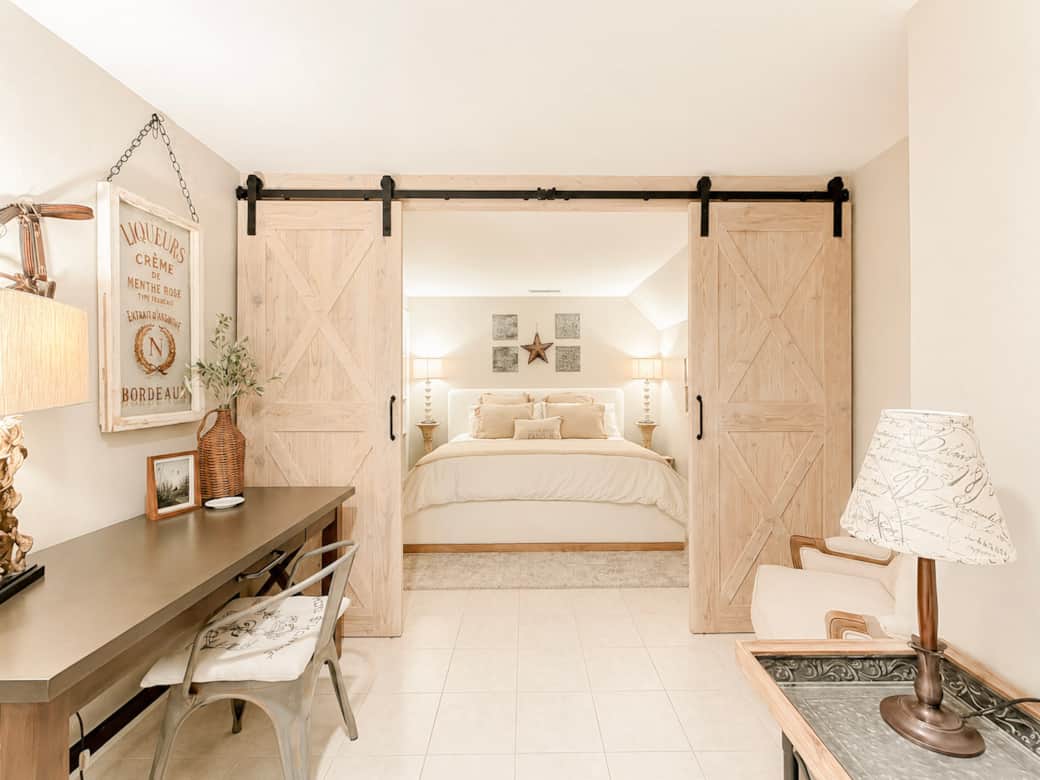Sliding barn doors separate the bedroom from the reading and work area