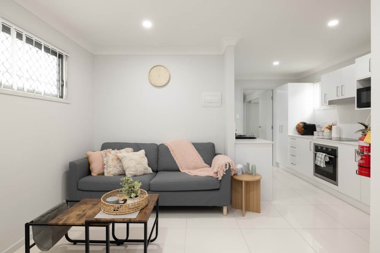 Living Area: Bright living space with comfortable seating and TV 