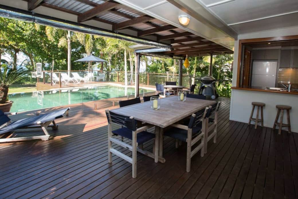 The Beach Cottage - Beachside patio with BBQ and dining table/seating area with access to pool.