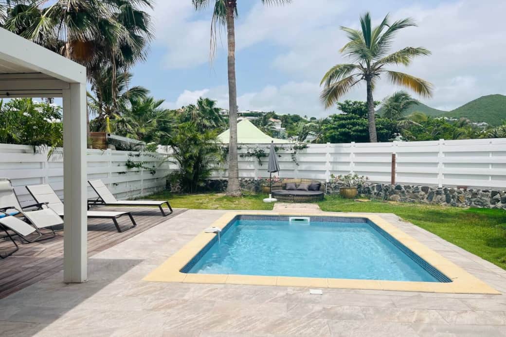 Swimming pool with deck chairs and garden Soliti