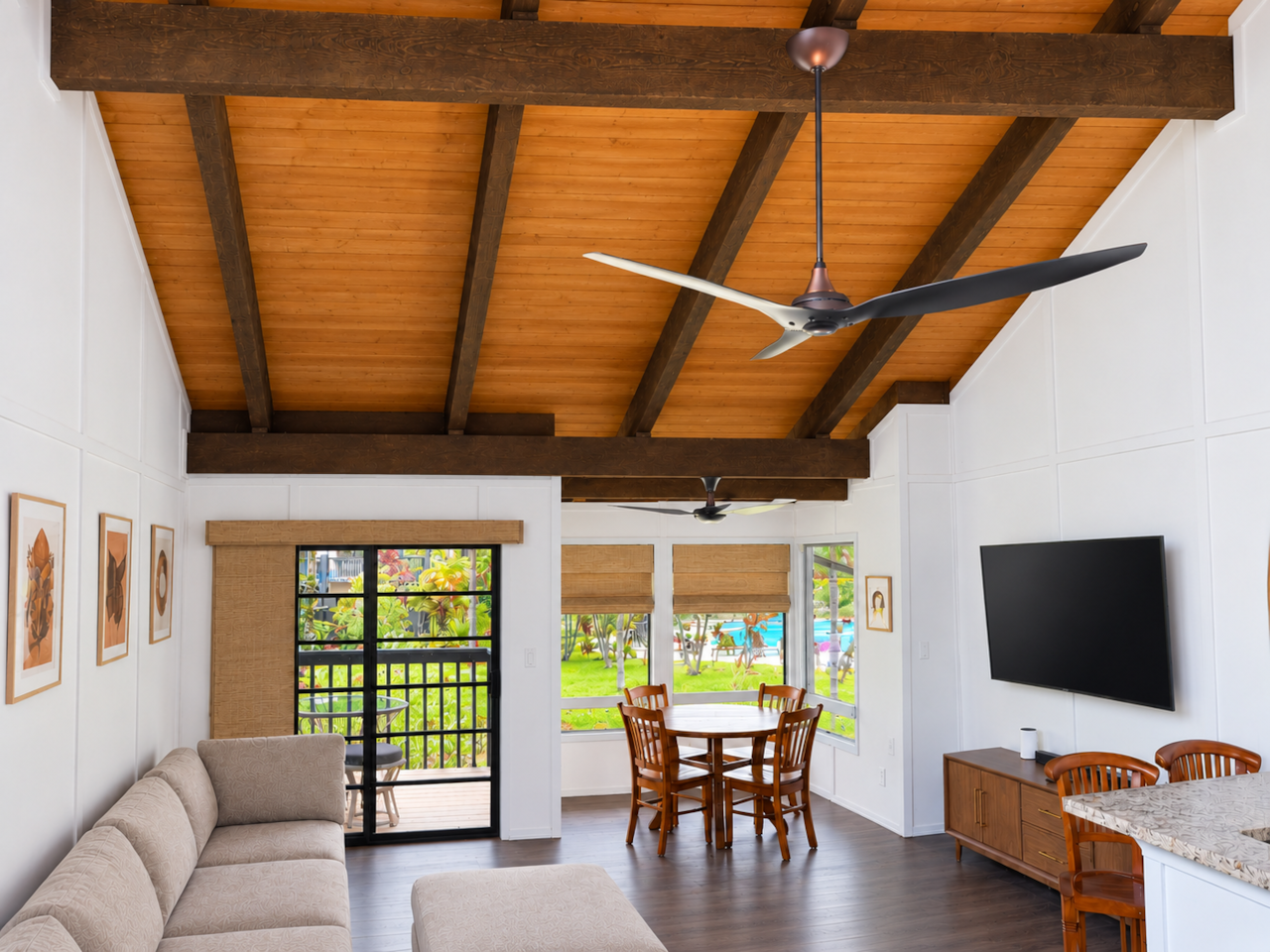 Open living area with vaulted wood ceiling and exposed beams