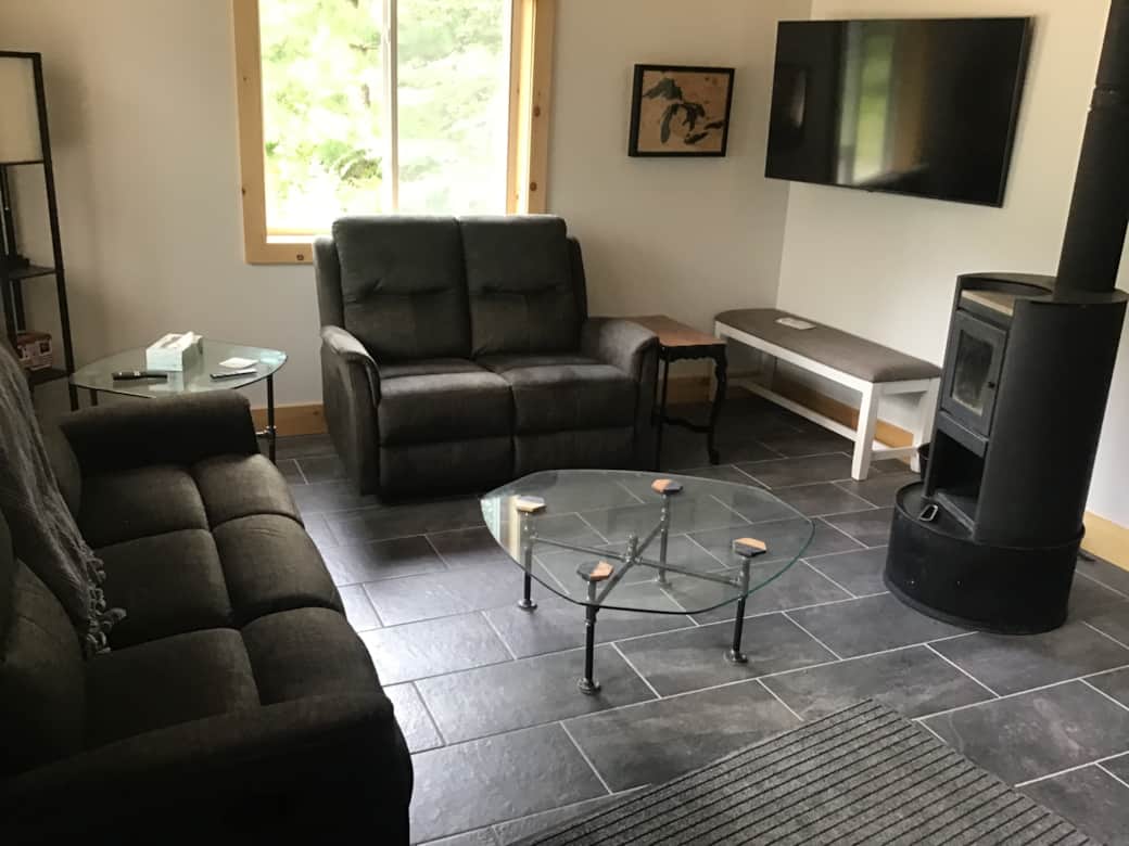 4 reclining seats, TV and wood stove.