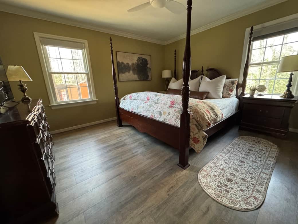 Main bedroom features a king size bed with Tempur-Pedic mattress, adjustable bed frame and black out shades.