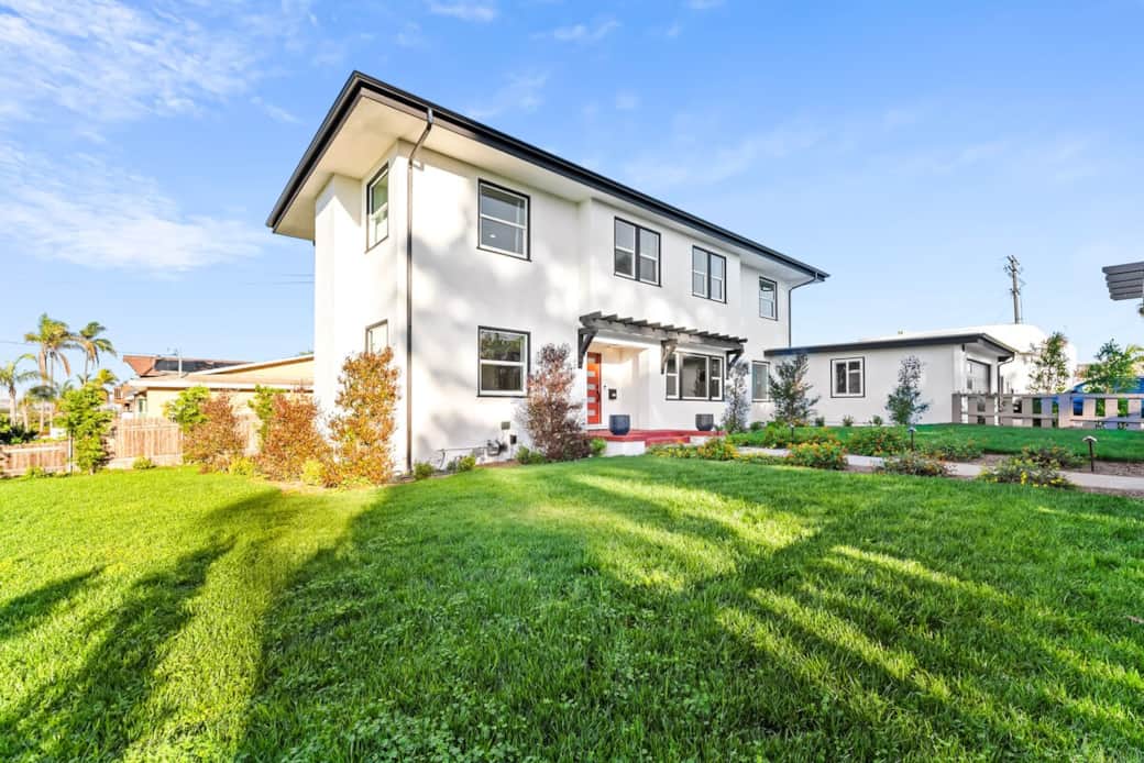 Exterior view with bright finish and lush landscaping.