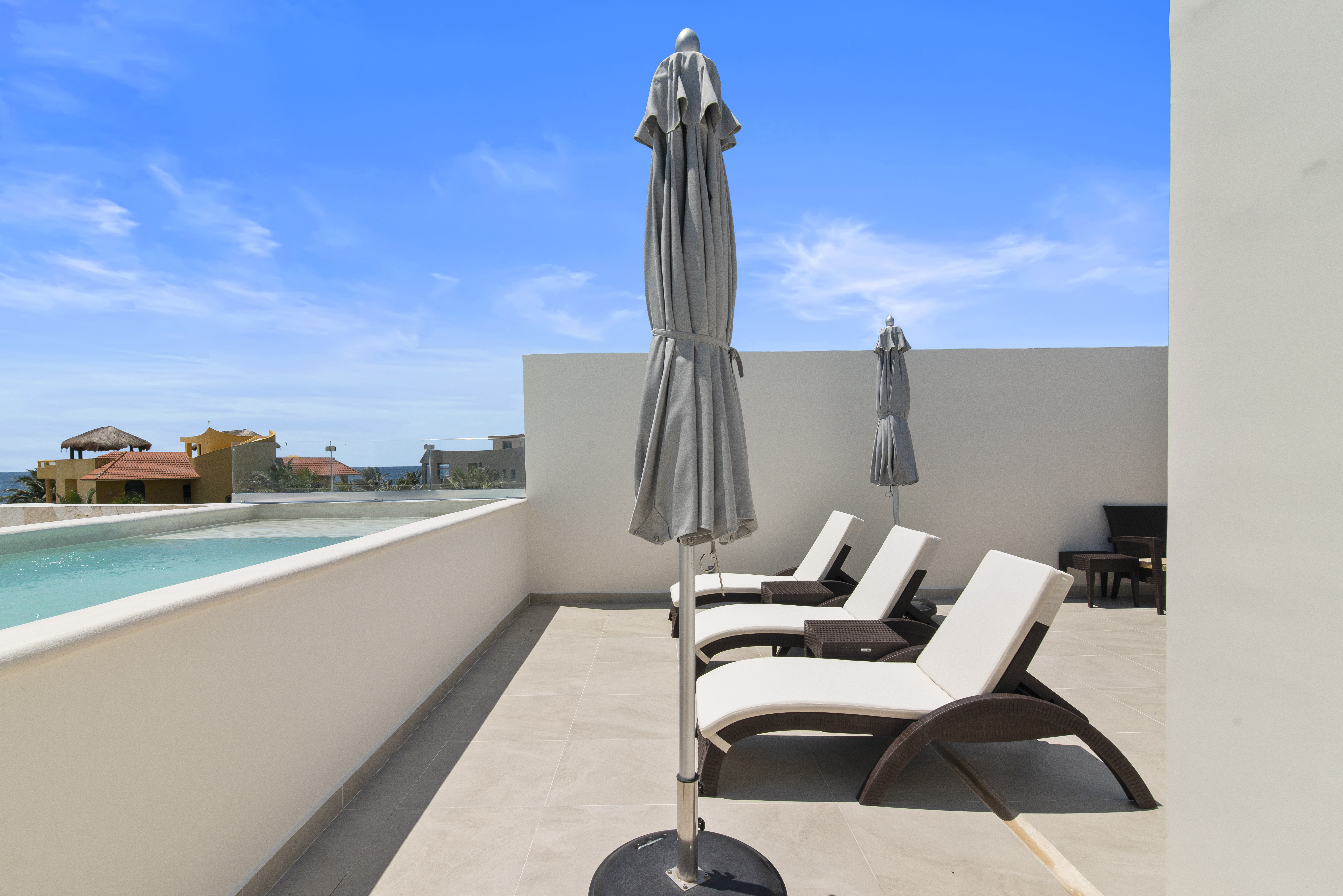 Rooftop pools with loungers, umbrellas, and breathtaking views of the Caribbean Sea.