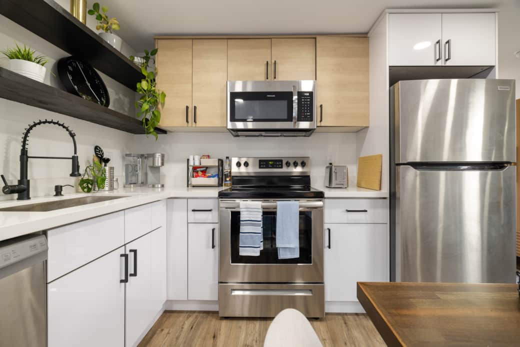 full sized kitchen w/ dishwasher, oven, microwave, and full sized fridge