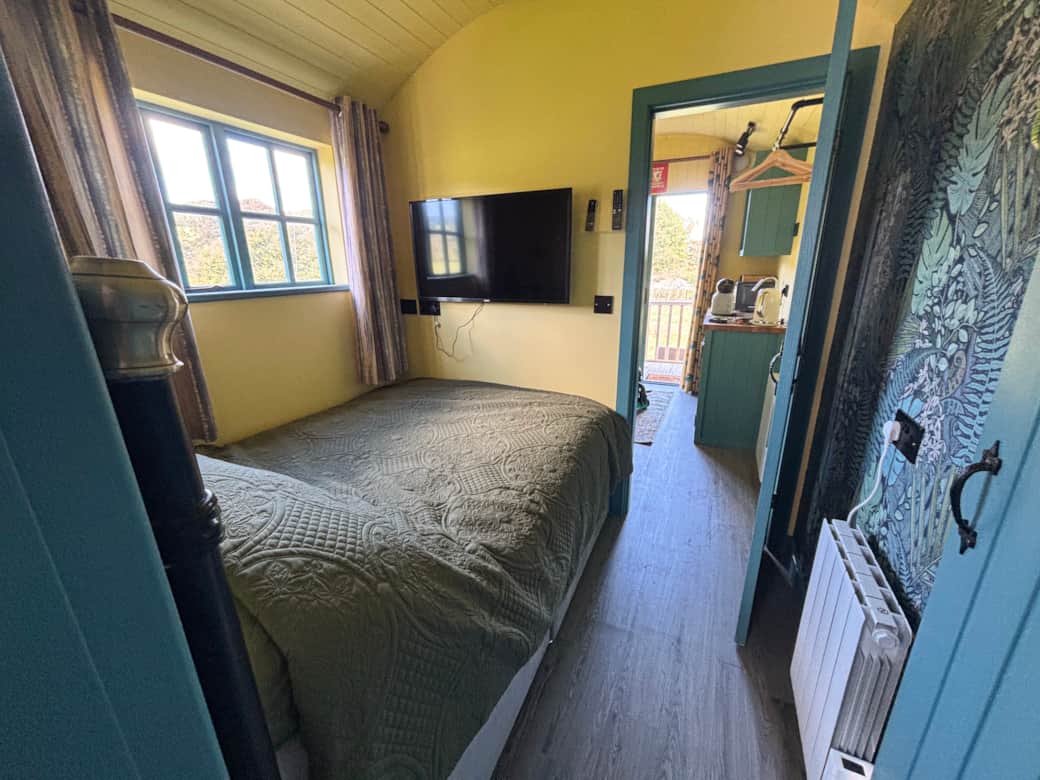Cosy double bedroom with TV and countryside window views.