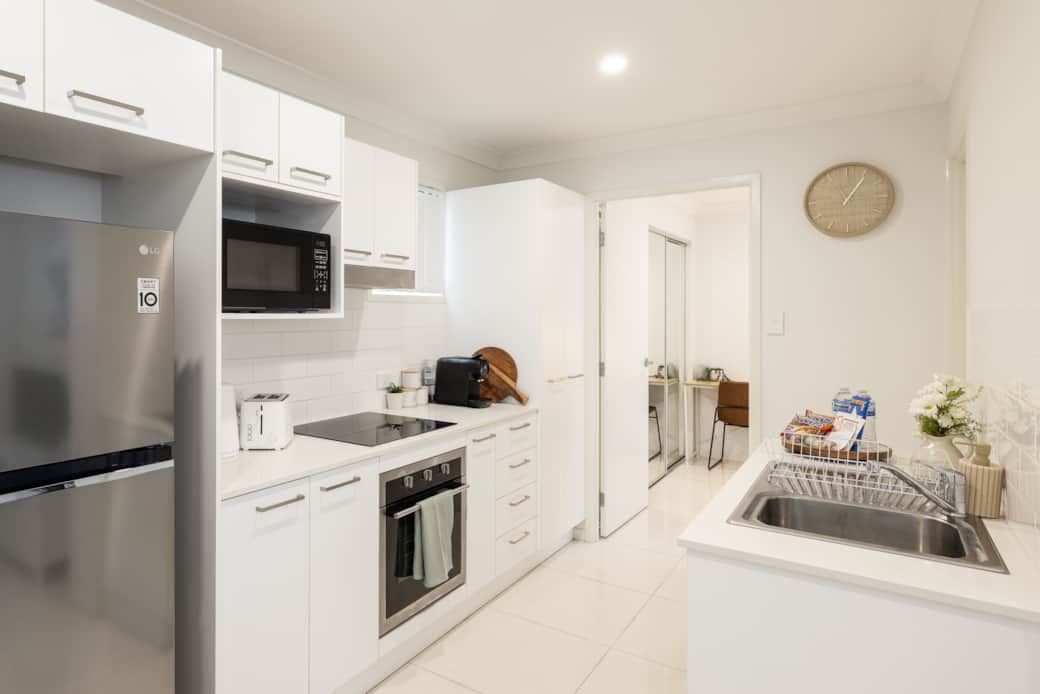Kitchen: Sleek kitchen with ample storage, modern appliances 