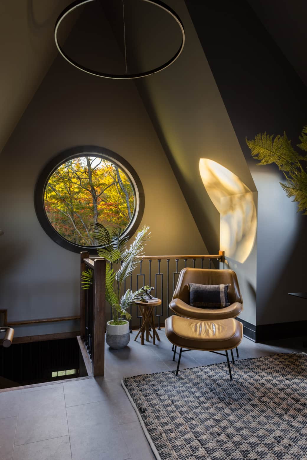 Cozy reading nook anchored by a leather chair and warm textures