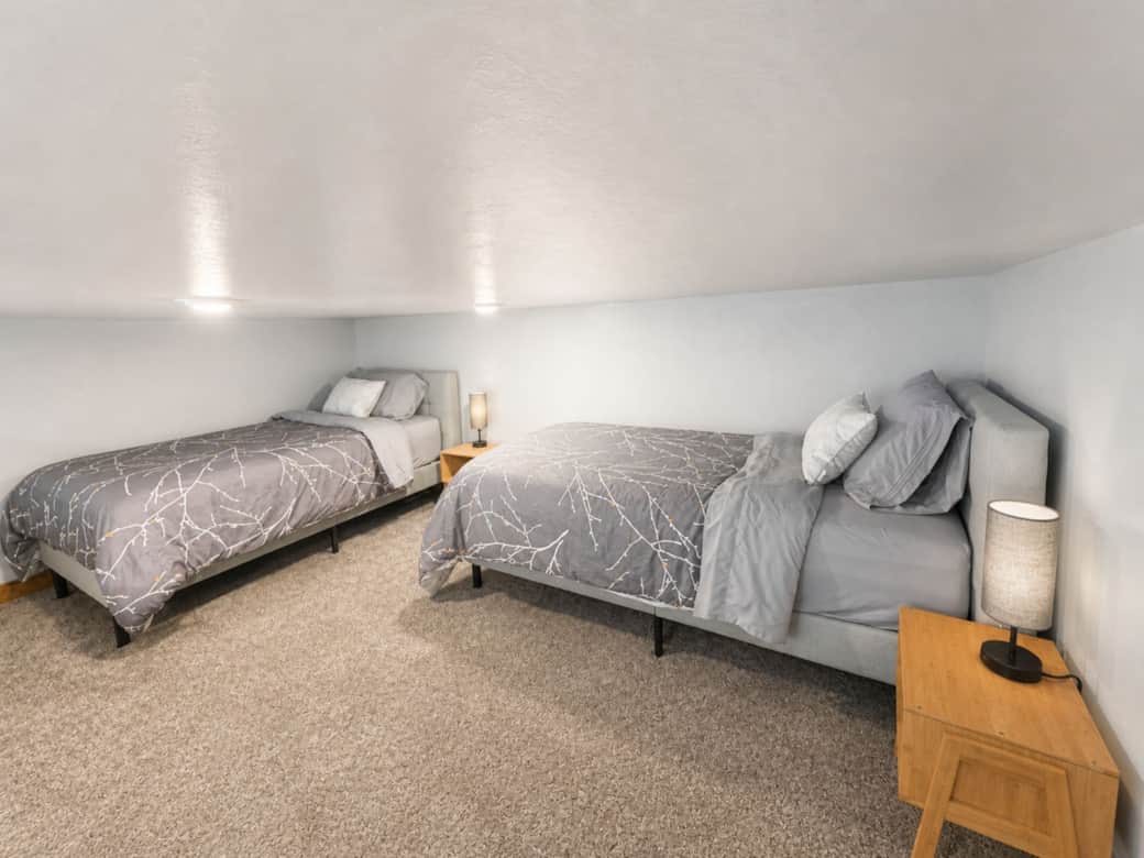 Airy view of the loft sleeping area which overlooks the main level in the Black Hills, SD.
