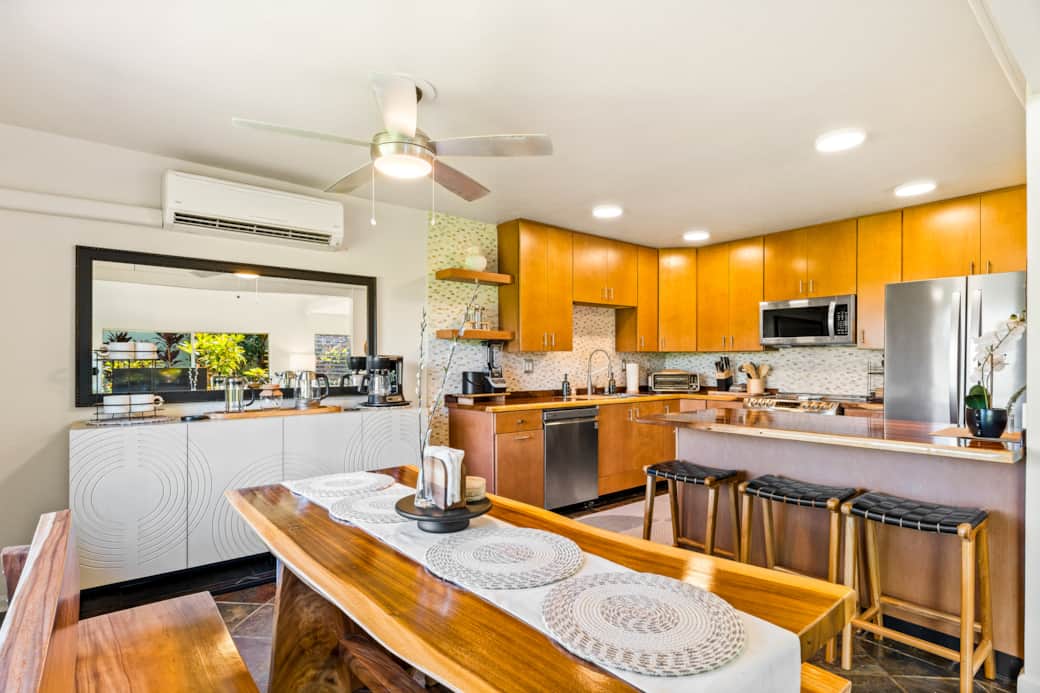 The warm wood tones and sleek appliances create the perfect backdrop for gatherings