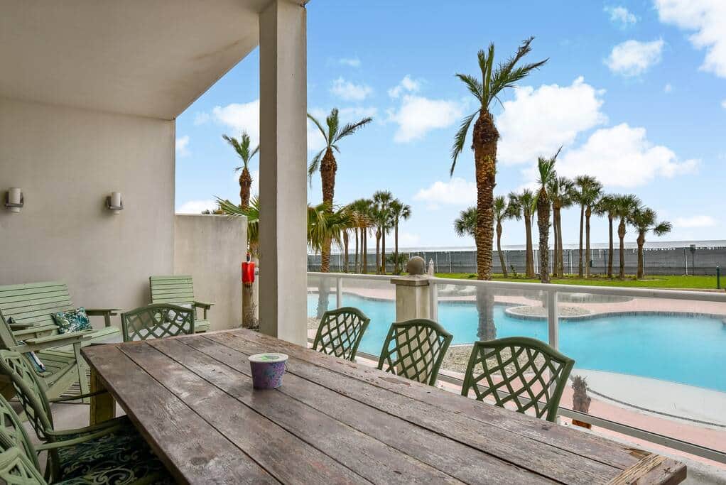 Large balcony with seating area and table