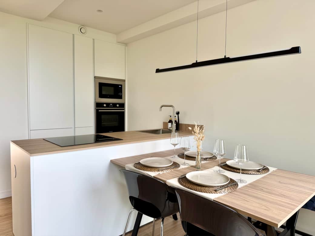 Modern kitchen with set table and warm tones, ready for a quiet meal at home. Modern kitchen with set table and warm tones, ready for a quiet meal at home.