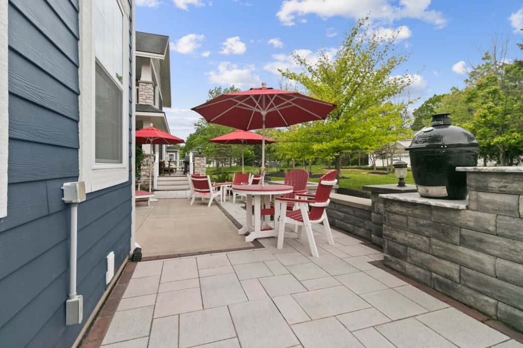 Private outdoor patio with red umbrellas, dining space, and luxury outdoor kitchen at The Blue Grasshopper. Private outdoor patio with red umbrellas, dining space, and luxury outdoor kitchen at The Blue Grasshopper.