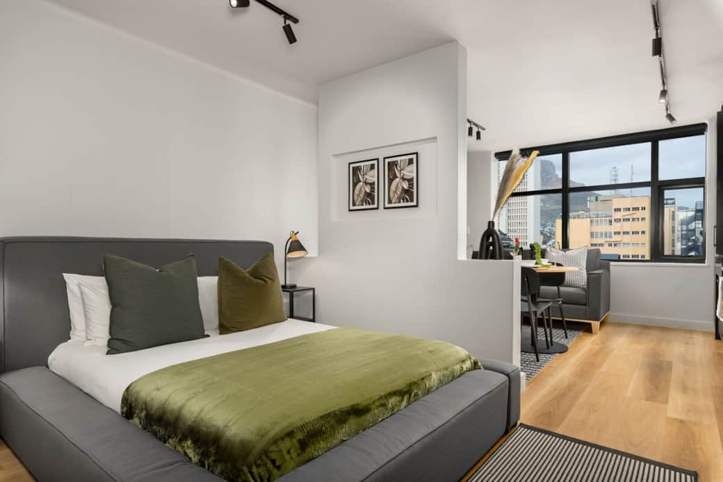 Bedroom with views of Table mountain upon entry- Double size bed, extra blankets, white linens, artworks, rug and mirror 