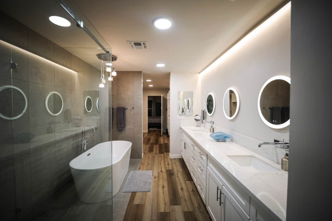 Primary bathroom with a freestanding soaking tub, walk-in shower and double vanity.