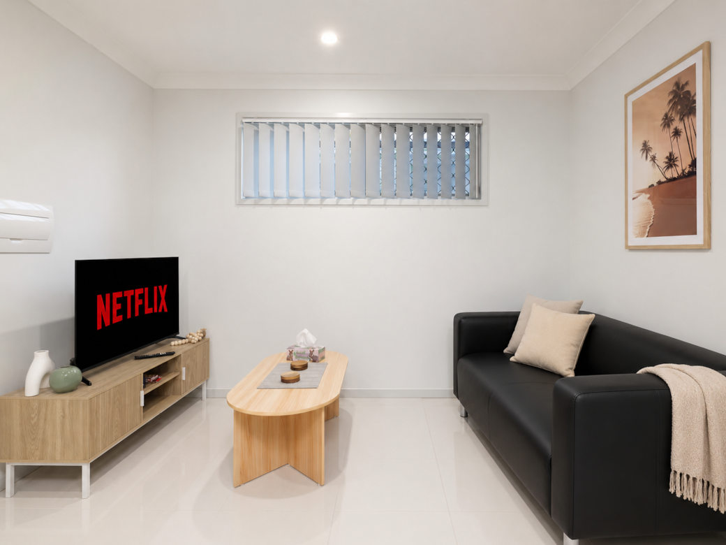 Living Area: Bright living space with comfortable seating and TV 