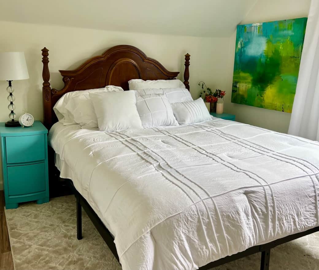 Serene and restful. This queen bedroom features soft linens, a variety of pillows, and peaceful mountain views. On Sundays, you might hear the gentle ring of church bells from just down the street.